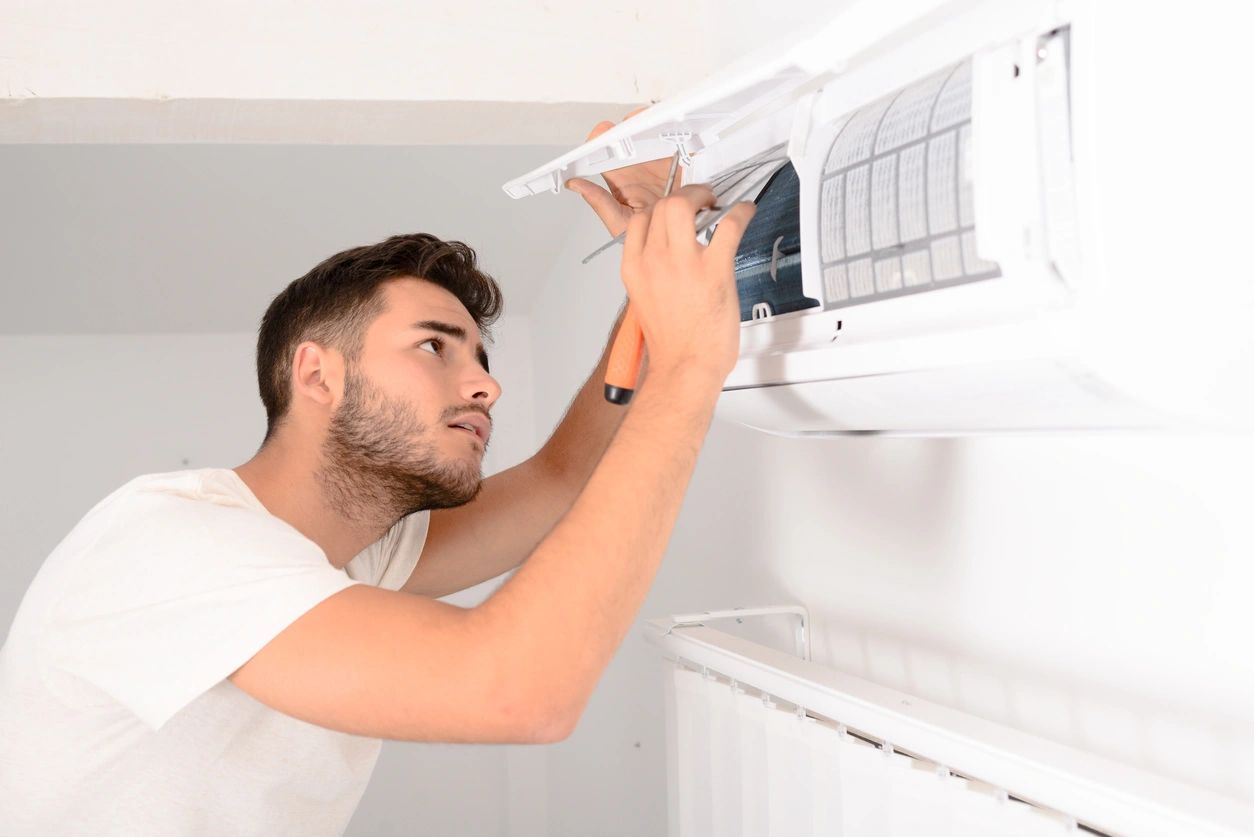 man cleaning air filter